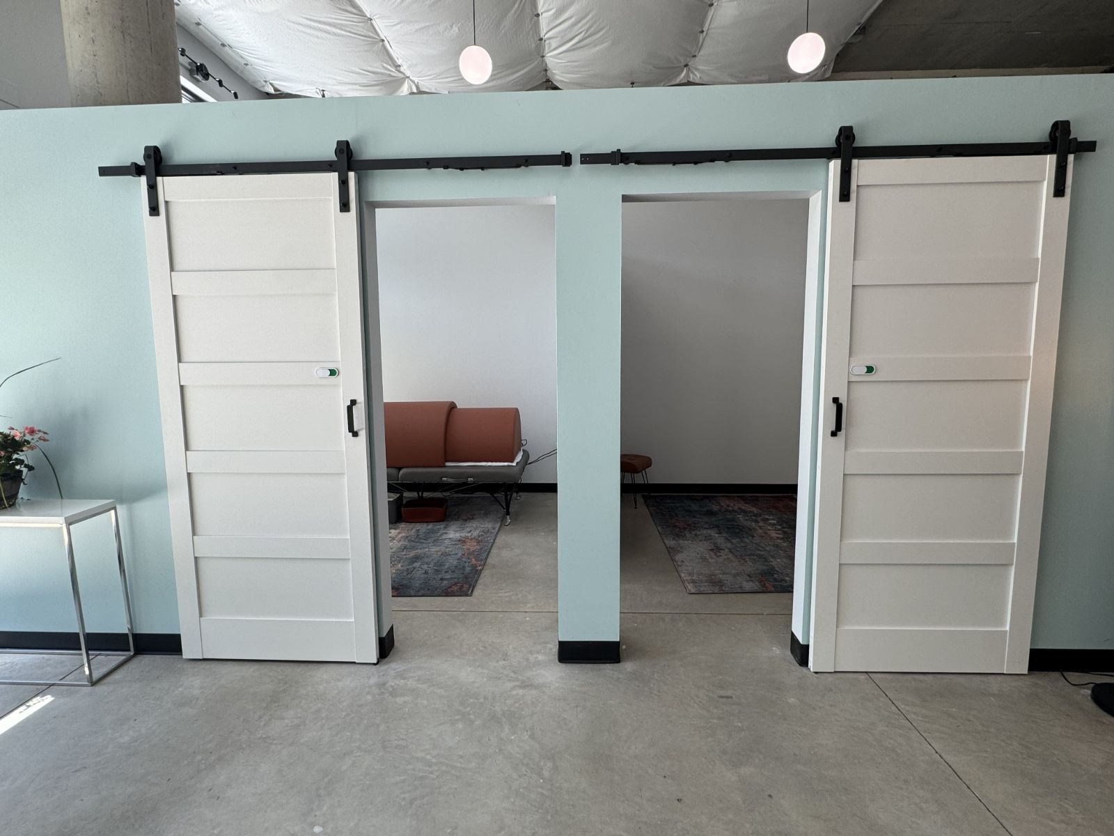 Hallway with sliding barn doors to private recovery rooms