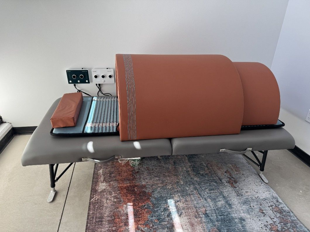 Solo infrared sauna dome on a massage table, with your head outside the heat